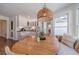 Bright breakfast nook features a round wooden table, banquette seating and stylish lighting fixture at 170 River Cove Rdg, Social Circle, GA 30025
