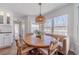 Charming breakfast nook features a cozy bench, decorative lighting and natural light at 170 River Cove Rdg, Social Circle, GA 30025