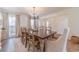 Elegant dining room with dark wood table and a view of the staircase at 170 River Cove Rdg, Social Circle, GA 30025