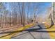 Long driveway leading to a charming home nestled among tall trees, offering privacy and a peaceful setting at 170 River Cove Rdg, Social Circle, GA 30025