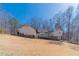 Charming home featuring a large backyard, a wooden deck, and beautiful landscaping for serene outdoor living at 170 River Cove Rdg, Social Circle, GA 30025