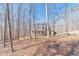 Beautiful two-story home with a covered porch surrounded by mature trees and natural landscaping at 170 River Cove Rdg, Social Circle, GA 30025