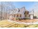 Inviting two-story home with a classic covered porch and professionally landscaped yard and walkway at 170 River Cove Rdg, Social Circle, GA 30025