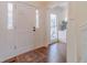 Bright foyer and front door with sidelights, hardwood floors and access to porch at 170 River Cove Rdg, Social Circle, GA 30025