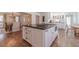 Gourmet kitchen boasts a center island with cooktop, modern cabinetry, and hardwood floors at 170 River Cove Rdg, Social Circle, GA 30025