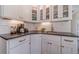 Modern kitchen features white cabinets, subway tile backsplash, and sleek countertops at 170 River Cove Rdg, Social Circle, GA 30025