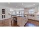Modern kitchen features a center island, stylish stools, and ample counter space at 170 River Cove Rdg, Social Circle, GA 30025