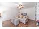 Inviting living room featuring a comfortable sofa, bookshelves, and hardwood floors at 170 River Cove Rdg, Social Circle, GA 30025
