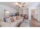 Inviting living room with hardwood floors, bookshelves, and bright natural light at 170 River Cove Rdg, Social Circle, GA 30025