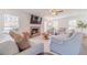 Open living room with a brick fireplace, large windows, and cozy seating at 170 River Cove Rdg, Social Circle, GA 30025