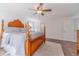 Bright main bedroom featuring a wooden bed frame, ceiling fan, and neutral walls at 170 River Cove Rdg, Social Circle, GA 30025