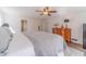 Spacious main bedroom showcasing wood floors, a ceiling fan, and plenty of natural light at 170 River Cove Rdg, Social Circle, GA 30025