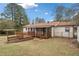 Spacious backyard featuring a carport, a shed, wood deck, screened-in porch and mature trees at 4760 Lincoln Drive Ne Dr, Kennesaw, GA 30144