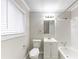 Bathroom featuring a white single sink vanity, a toilet, and a shower over tub with white tile surround at 6202 Humphries Hill Rd, Austell, GA 30106