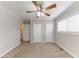 Bedroom features neutral carpeting, dual closets, and a ceiling fan at 6202 Humphries Hill Rd, Austell, GA 30106