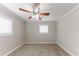Bedroom with a ceiling fan, plush carpeting, and natural light at 6202 Humphries Hill Rd, Austell, GA 30106