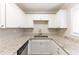 Modern kitchen with white cabinets, granite countertops, stainless appliances, and plenty of counter space at 6202 Humphries Hill Rd, Austell, GA 30106