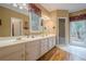 Bathroom with double vanity, granite countertops, and a separate shower and tub at 6360 Brookline Ct, Cumming, GA 30040
