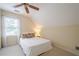 A cozy bedroom with a ceiling fan, large window, and comfortable bedding creates a relaxing retreat at 6360 Brookline Ct, Cumming, GA 30040