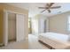 Neutral bedroom with a ceiling fan and closets, offering ample storage space and comfort at 6360 Brookline Ct, Cumming, GA 30040