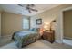 Cozy bedroom featuring a floral bedspread, wooden nightstand, and soft natural light at 6360 Brookline Ct, Cumming, GA 30040