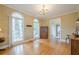 Elegant dining room with hardwood floors, bright natural light, and traditional chandelier at 6360 Brookline Ct, Cumming, GA 30040