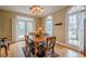 Formal dining room with hardwood floors, natural light, and classic chandelier at 6360 Brookline Ct, Cumming, GA 30040