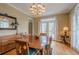 Dining room features wood table, hardwood floors, and large windows at 6360 Brookline Ct, Cumming, GA 30040