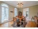 Formal dining room with hardwood floors, large windows, and chandelier lighting at 6360 Brookline Ct, Cumming, GA 30040