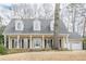 Charming two-story home with a large front porch, classic columns, and well-manicured lawn at 6360 Brookline Ct, Cumming, GA 30040
