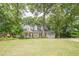 Charming two-story home with a large front yard and mature trees, offering great curb appeal at 6360 Brookline Ct, Cumming, GA 30040