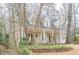 Inviting home showcasing a covered front porch with rocking chairs and mature trees in the front yard at 6360 Brookline Ct, Cumming, GA 30040