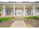 Charming covered porch with rocking chairs and stone steps leading to the front door at 6360 Brookline Ct, Cumming, GA 30040