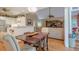 Open kitchen and living area with white cabinets, stainless steel appliances, and a breakfast bar for casual dining at 6360 Brookline Ct, Cumming, GA 30040