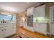 Eat-in kitchen with white cabinets, stainless steel appliances, and hardwood floors at 6360 Brookline Ct, Cumming, GA 30040