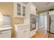 Kitchen features white cabinets, stainless steel appliances, and hardwood flooring at 6360 Brookline Ct, Cumming, GA 30040