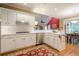 Spacious kitchen with white cabinets, stainless steel appliances, and an island with seating at 6360 Brookline Ct, Cumming, GA 30040