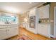 Open kitchen featuring white cabinetry, stainless appliances, and hardwood floors at 6360 Brookline Ct, Cumming, GA 30040