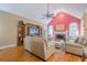 A living room featuring a fireplace, large windows, hardwood floors and comfortable seating at 6360 Brookline Ct, Cumming, GA 30040