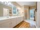 Spacious main bathroom featuring double sinks, and a large window for natural light at 6360 Brookline Ct, Cumming, GA 30040