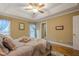 Comfortable bedroom boasts hardwood floors, neutral walls, tray ceilings, and lots of natural light at 6360 Brookline Ct, Cumming, GA 30040