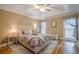 Cozy bedroom with tray ceilings, hardwood floors, and soft lighting, creating a serene retreat at 6360 Brookline Ct, Cumming, GA 30040