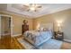 Comfortable bedroom with tray ceiling, hardwood floors, and a serene color scheme at 6360 Brookline Ct, Cumming, GA 30040