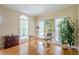 Well-lit home office with hardwood floors and ample natural light at 6360 Brookline Ct, Cumming, GA 30040