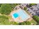 Aerial view of a large community pool with ample seating, surrounded by lush greenery and a parking lot at 6360 Brookline Ct, Cumming, GA 30040