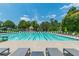 A community pool with lane markers and lifeguard chairs under a sunny blue sky at 6360 Brookline Ct, Cumming, GA 30040