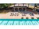 Aerial view of a community pool with lounge chairs and covered seating areas at 6360 Brookline Ct, Cumming, GA 30040