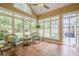Inviting sunroom with ample windows offering views of the backyard, with wicker furniture, ideal for relaxation at 6360 Brookline Ct, Cumming, GA 30040