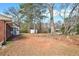 This backyard has lots of trees and a shed for storage at 999 Chestnut Oak Ct, Lawrenceville, GA 30046