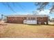 The backyard features a spacious lawn and a white picket fence with mature trees in the background at 999 Chestnut Oak Ct, Lawrenceville, GA 30046